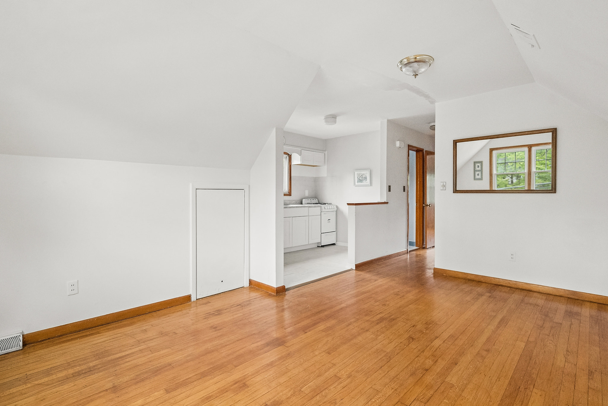 Add a small kitchenette table and a sofa to this small living room off of the kitchen.